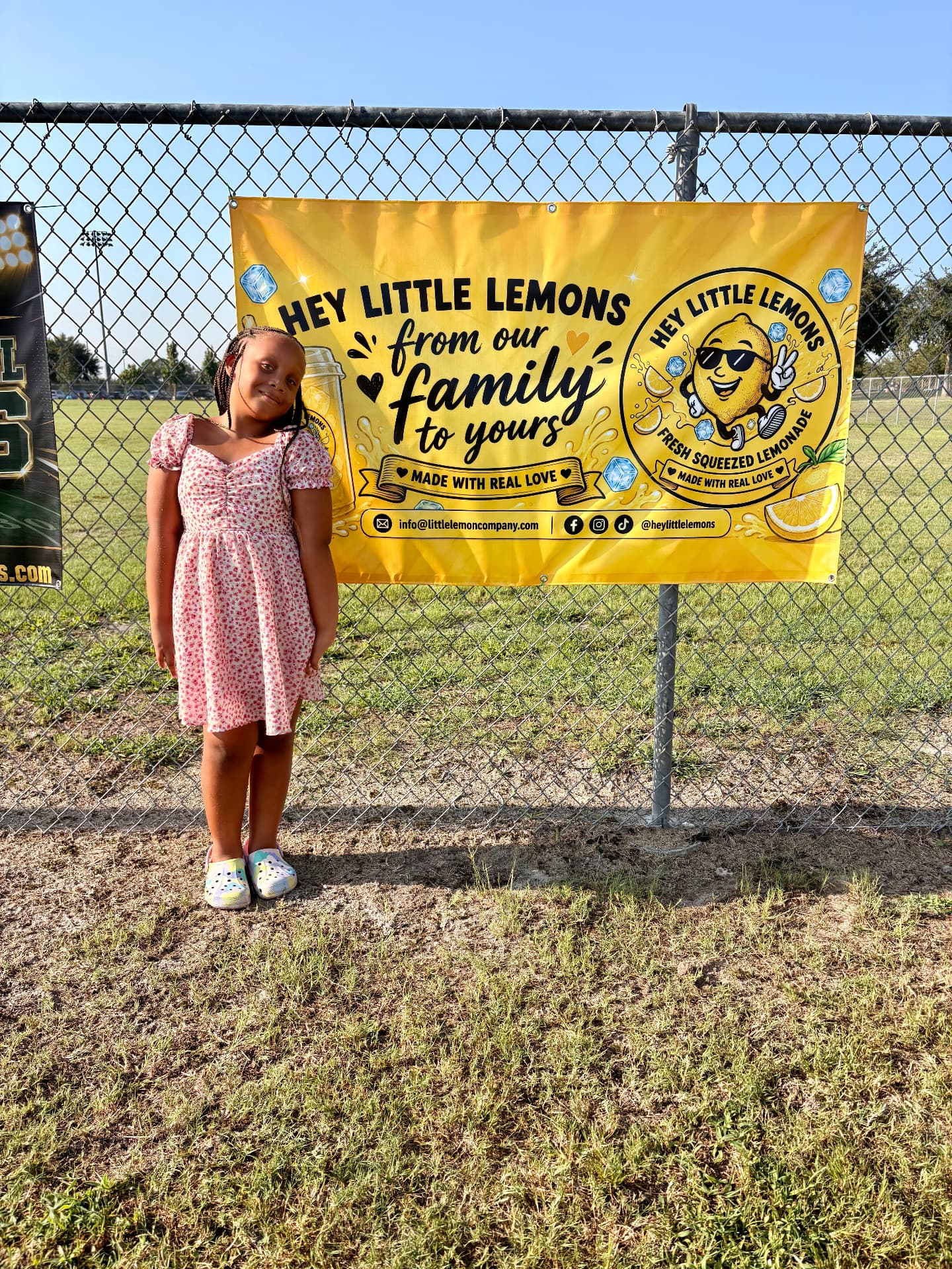 Rylee Washington standing beside the Hey Little Lemons banner reading 'From our family to yours — made with real love'